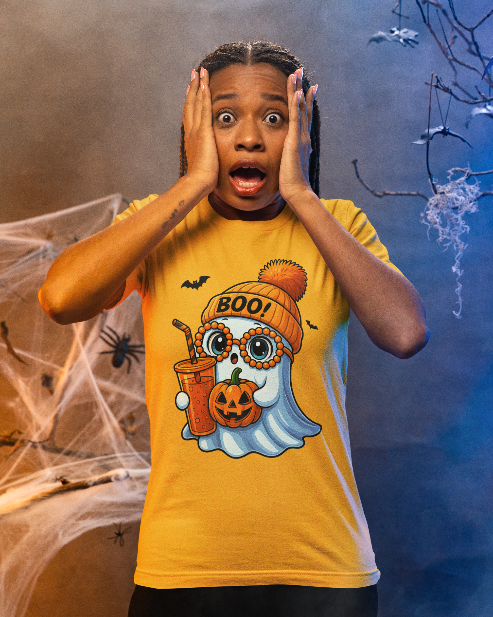 Child wearing a Halloween-themed t-shirt with ghost and pumpkin design, surrounded by spider webs and bats.