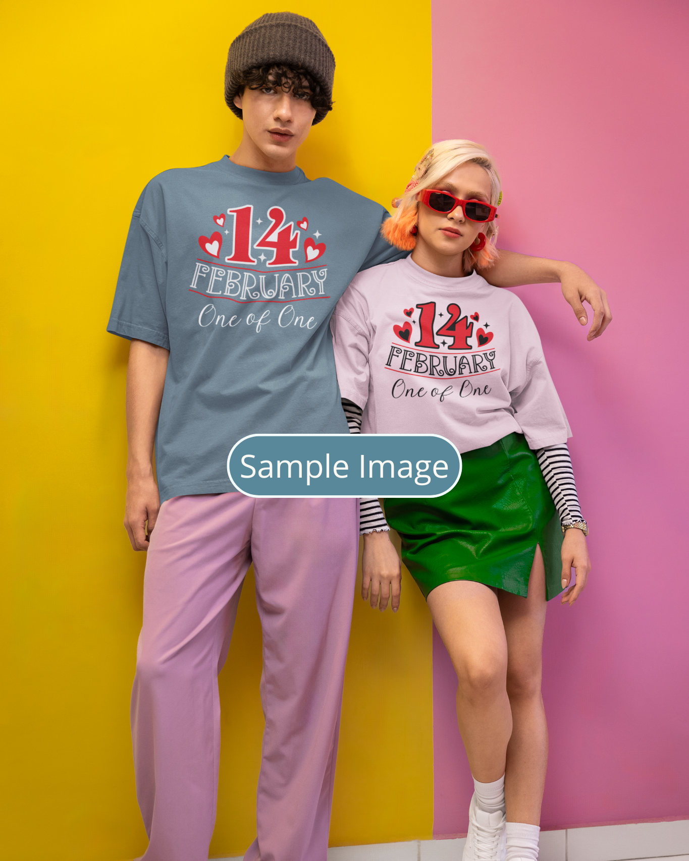 Two people wearing matching '14th February One of One' shirts against a colorful background.