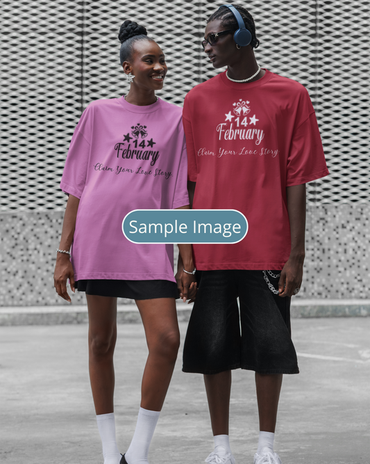 Two people wearing pink and red t-shirts with text, standing against a textured wall.