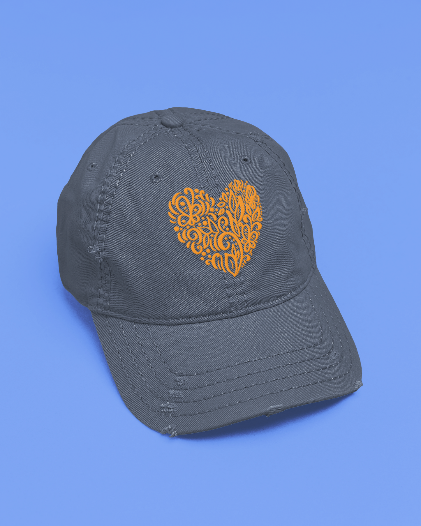Gray cap with a yellow heart design on a blue background