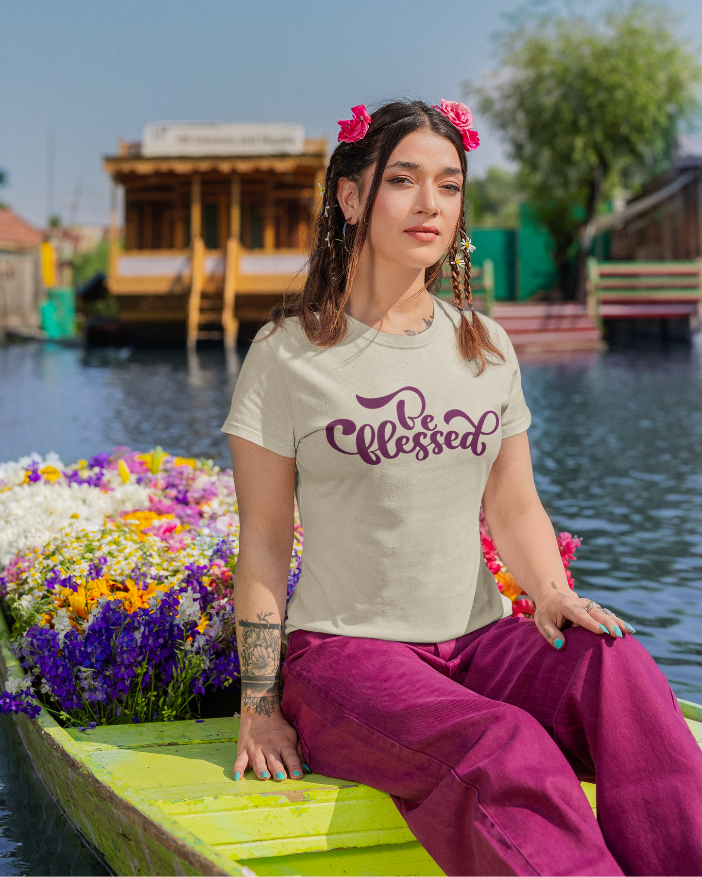 Woman sitting on a boat with houseboats and flowers in the background
