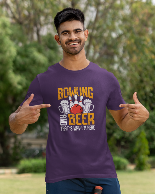 Man wearing a purple t-shirt with a colorful design, standing outdoors.