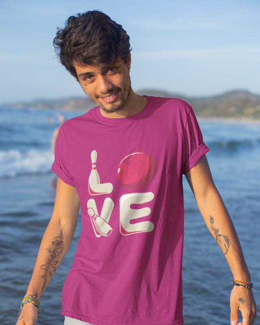 Man wearing a purple t-shirt with 'LOVE' printed on it at the beach.