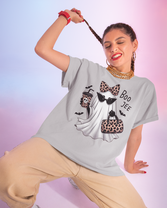 Woman wearing a gray t-shirt with a graphic design on a gradient background
