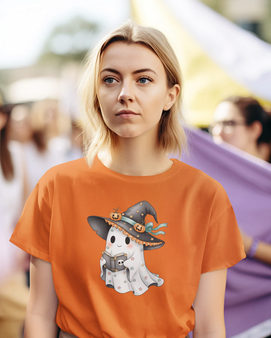 Woman wearing an orange t-shirt with a ghost and witch hat design.