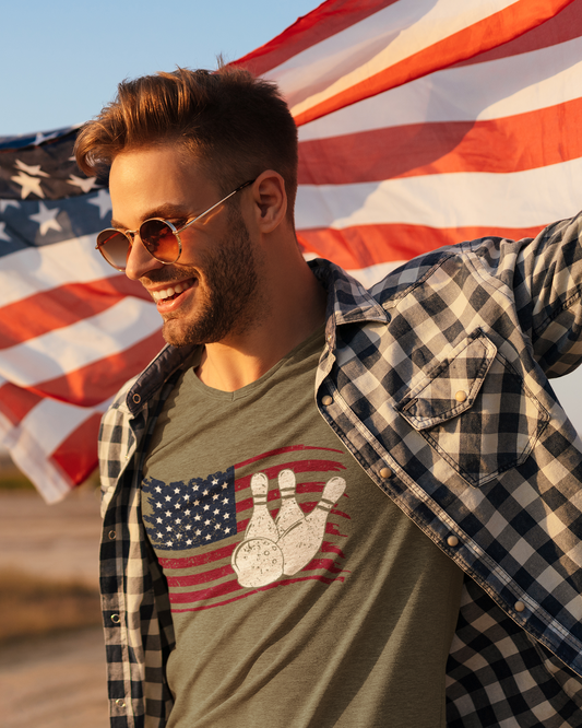 Man holding an American flag with a graphic t-shirt featuring an American flag design.