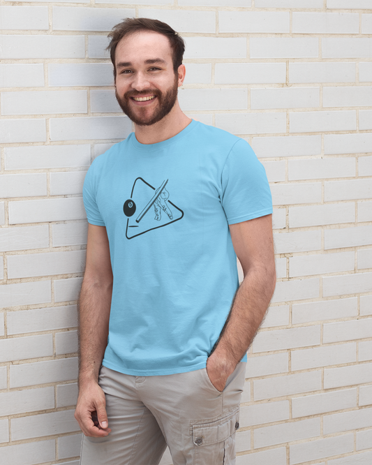 Man wearing a light blue t-shirt with a design against a white brick wall.