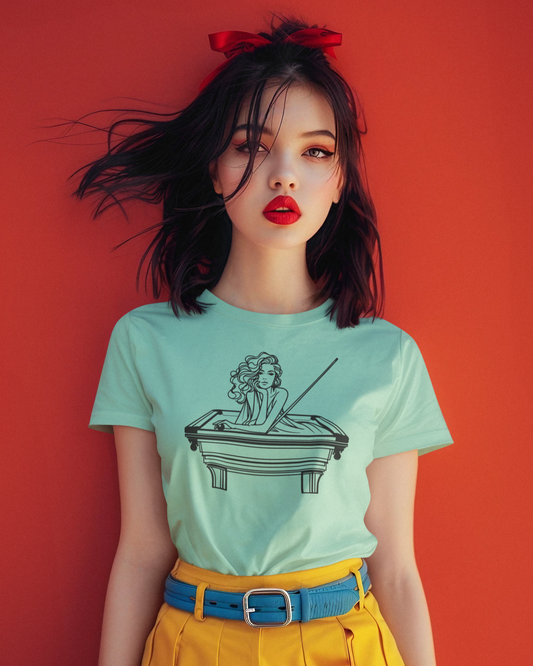 Woman wearing a light green t-shirt with a graphic design against a red background