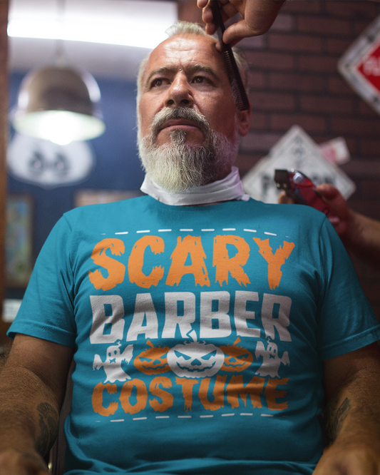 Man getting a haircut wearing a blue t-shirt with 'Scary Barber Costume' text in a barbershop.