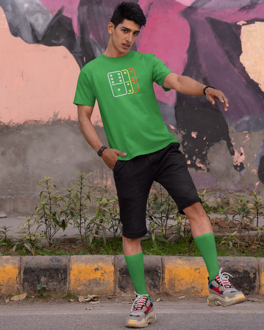 Person wearing a green t-shirt with a design, black shorts, and green socks standing in front of a colorful mural.
